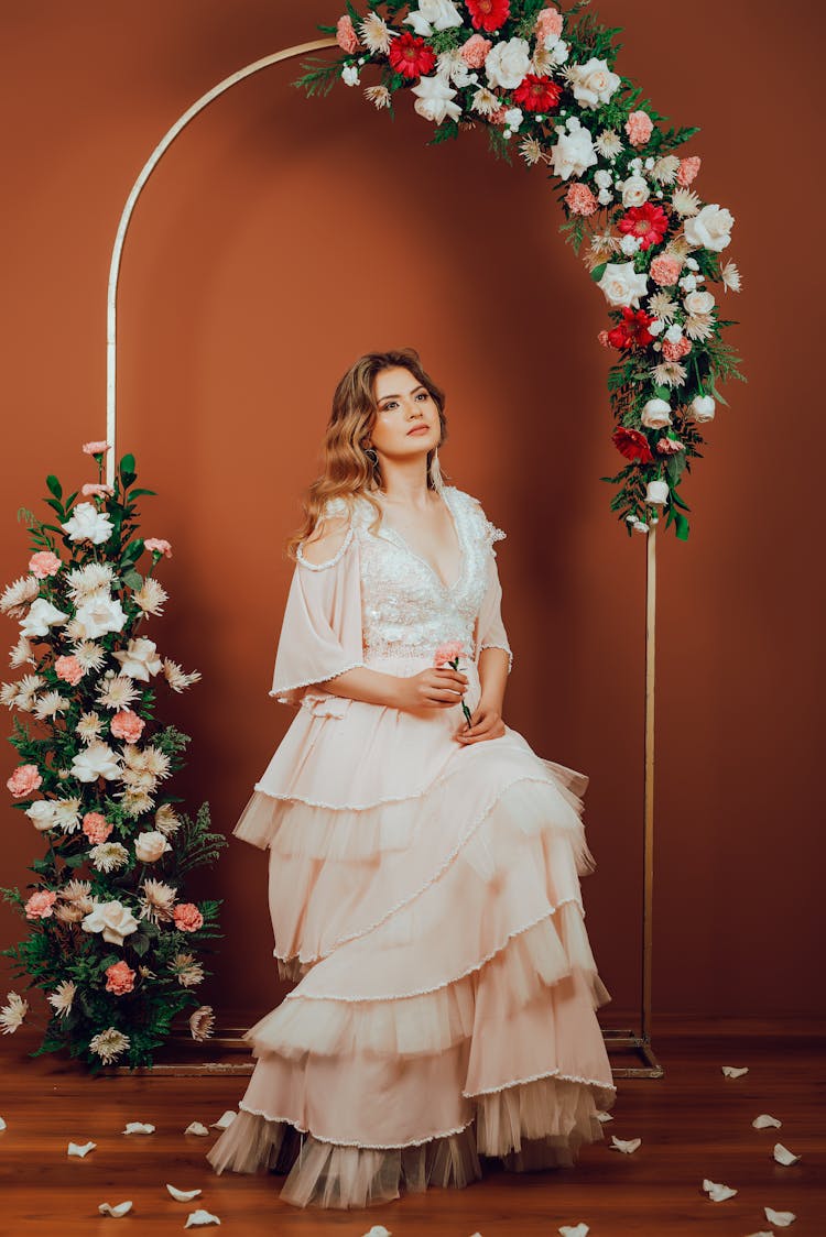 Woman In Dress Posing In Flower Arch