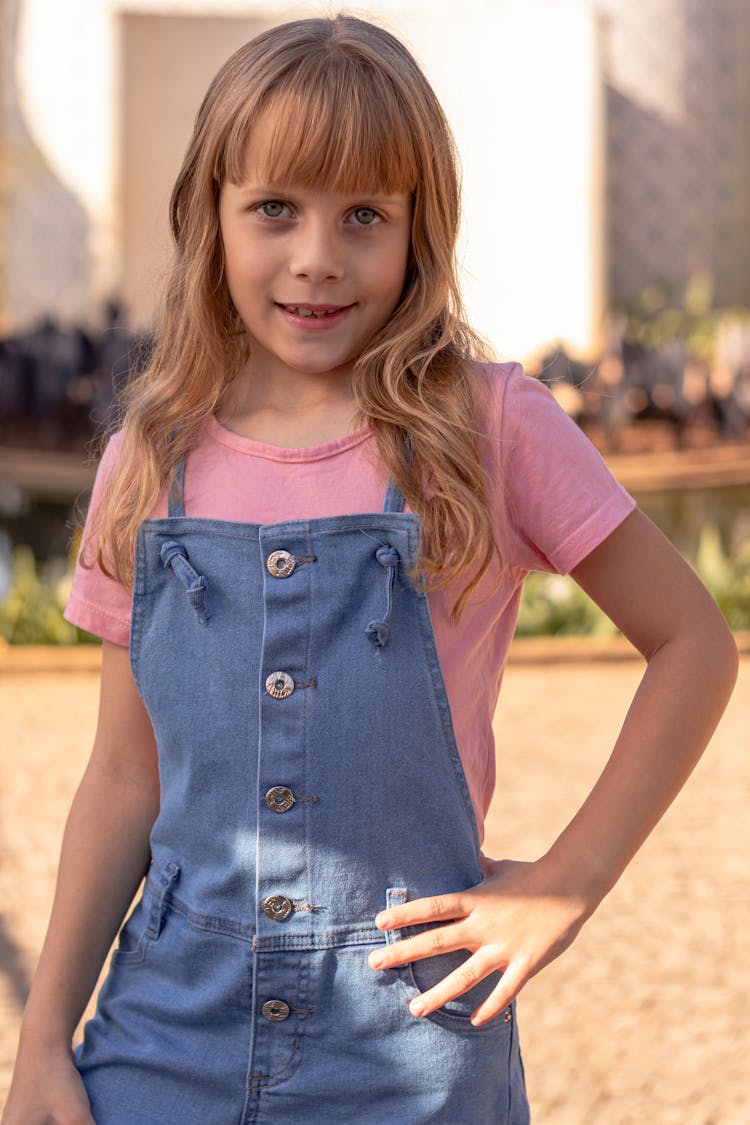 A Girl Wearing Blue Overalls