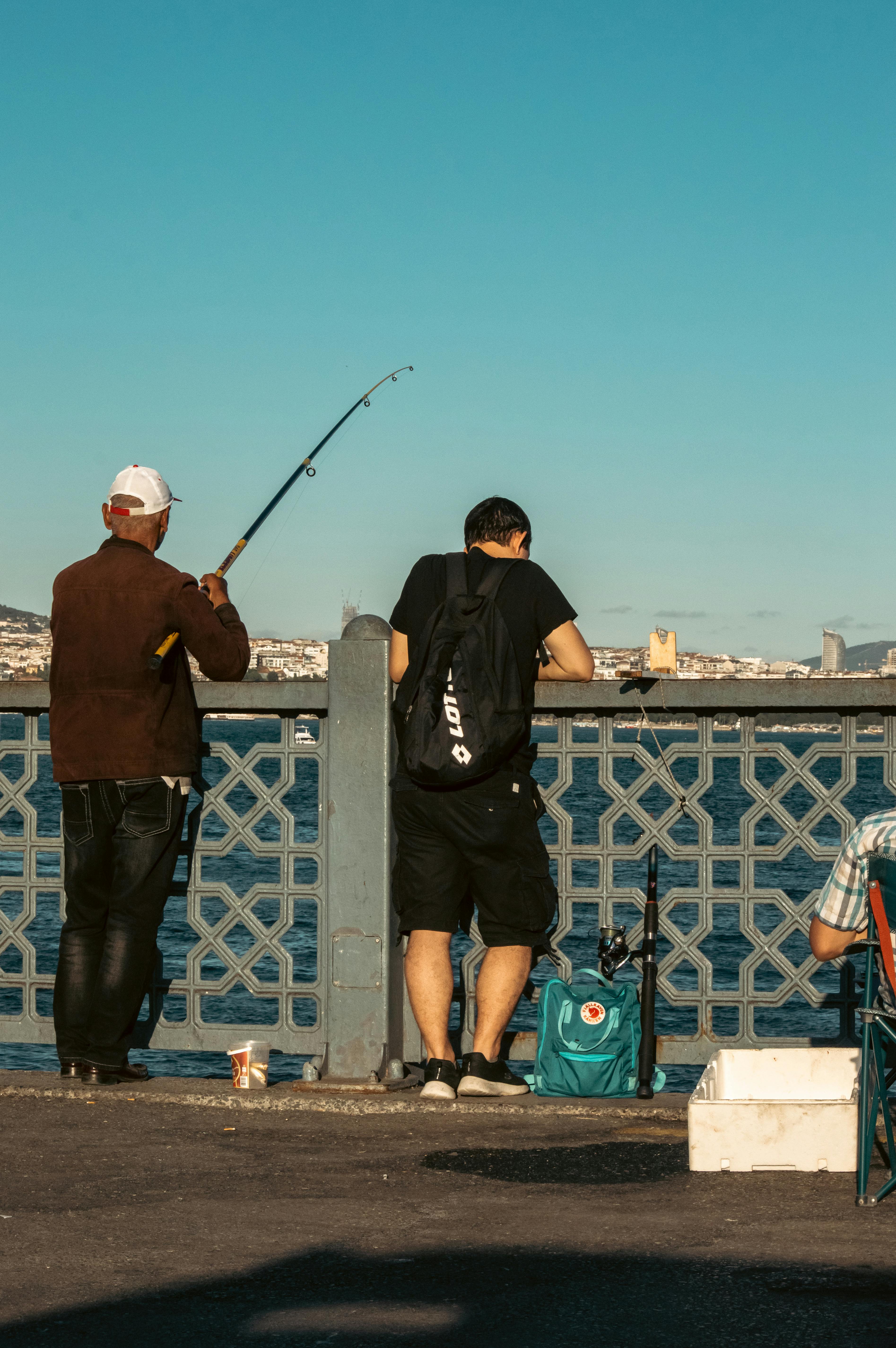 Men Fishing on a Bridge · Free Stock Photo