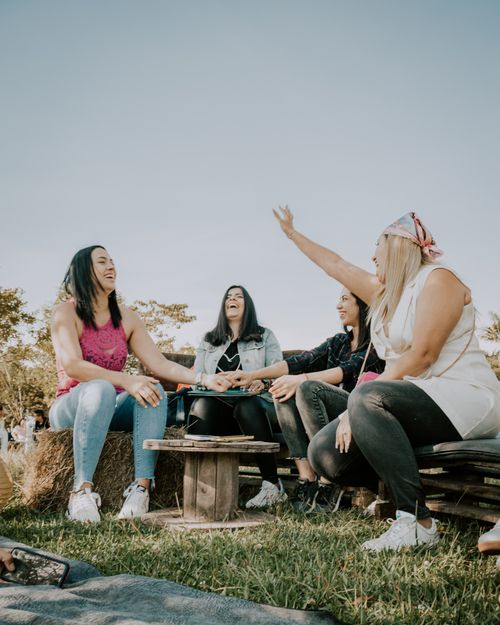 Free A joyful group of women enjoying a sunny day outdoors, laughing and bonding together. Stock Photo