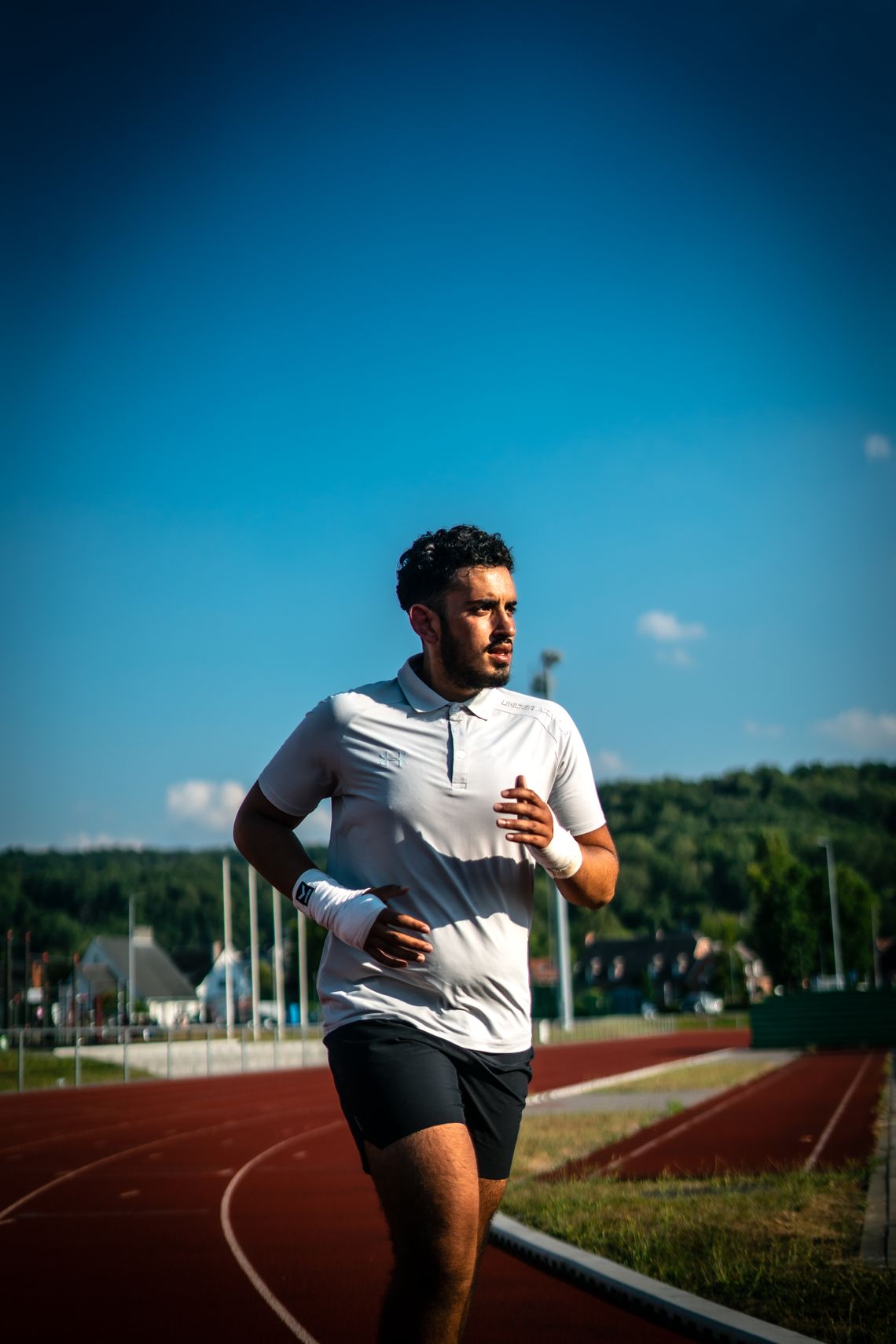Athlete running outdoors in a light performance top