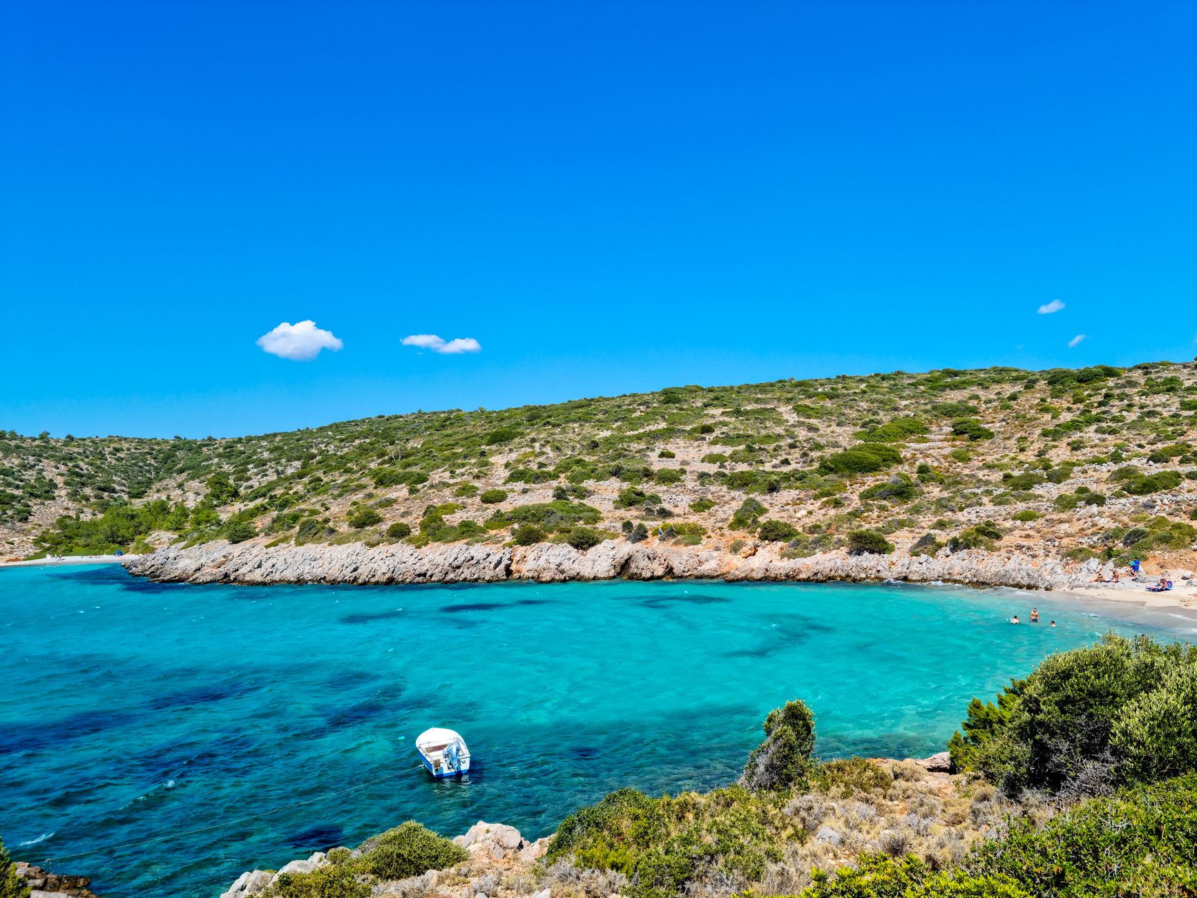 Capture of a serene Greek bay with turquoise waters and lush greenery, perfect for travel enthusiasts.
