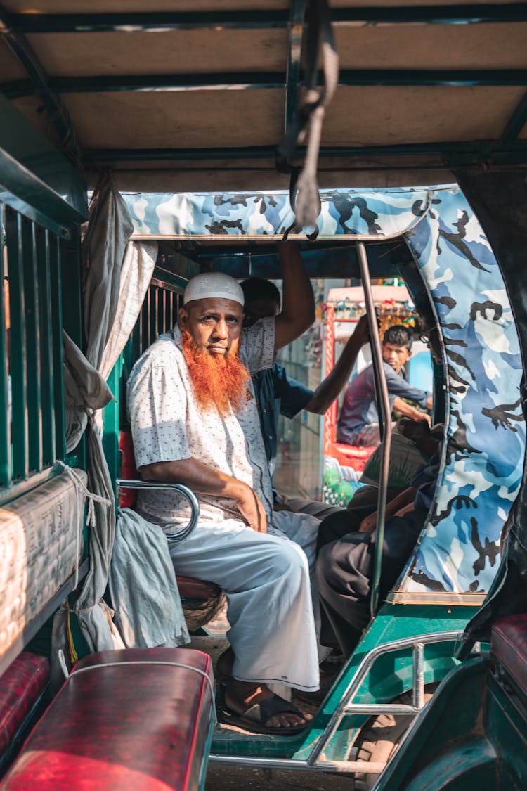 Men Riding A Vehicle Used For Public Transportation