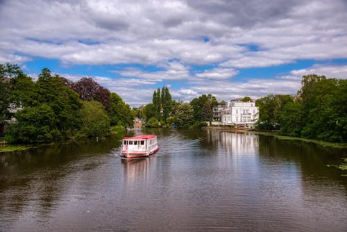 Ferry Boat on a River under a Cloudy Sky