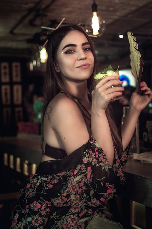 Woman Holding a Cocktail and a Fan