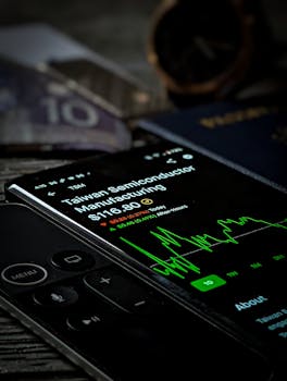 Smartphone with stock market graph showing Taiwan Semiconductor Manufacturing data.