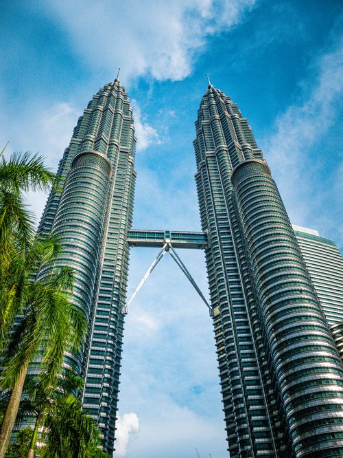 Free Stunning low angle shot of the Petronas Towers against a bright blue sky in Kuala Lumpur, Malaysia. Stock Photo