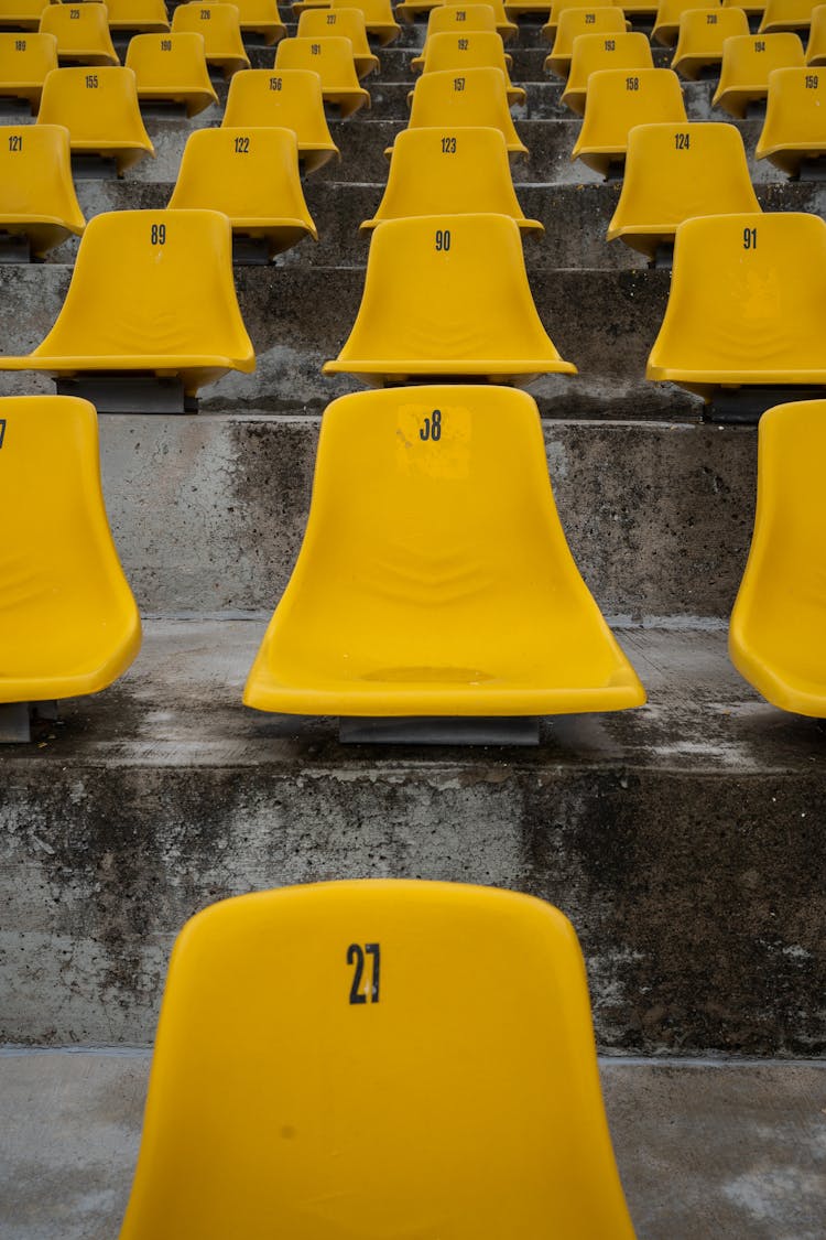 Yellow Plastic Chairs In A Stadium