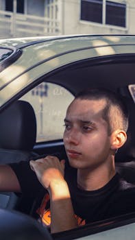 A young man sits in a car driving through San Juan Bautista Tuxtepec, Mexico.