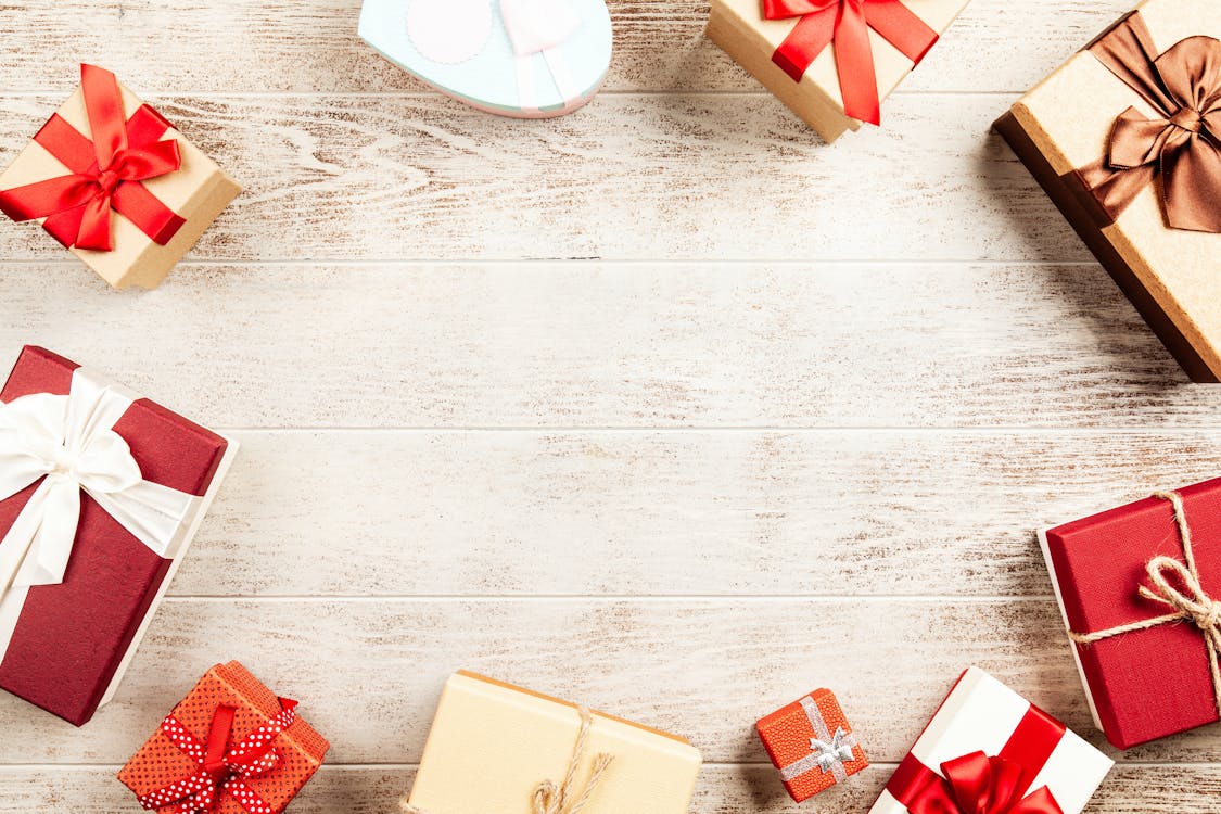 Assorted Gift Boxes on Wooden Surface · Free Stock Photo