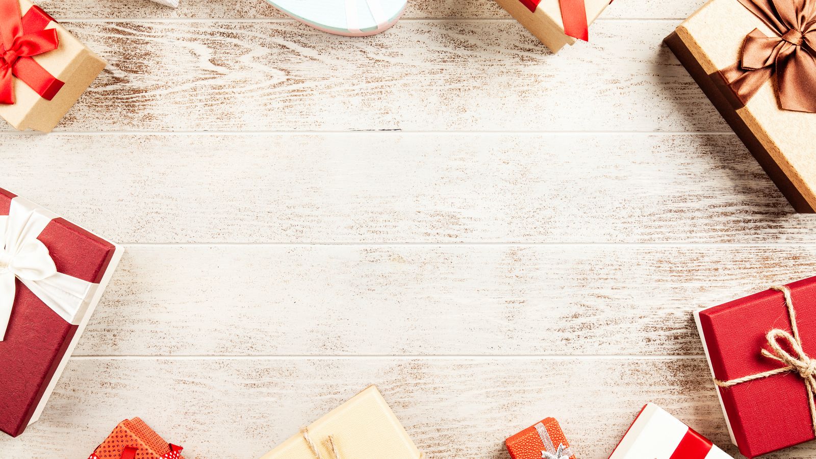 Flat lay of wrapped present boxes on a wooden table