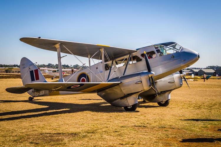 A Vintage Plane In An Airfield