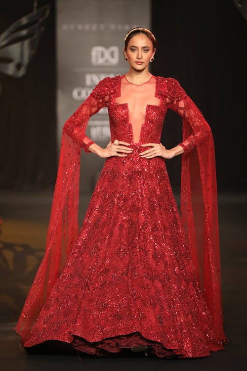 A Beautiful Woman in Red Gown with Her Hands on Her Waist
