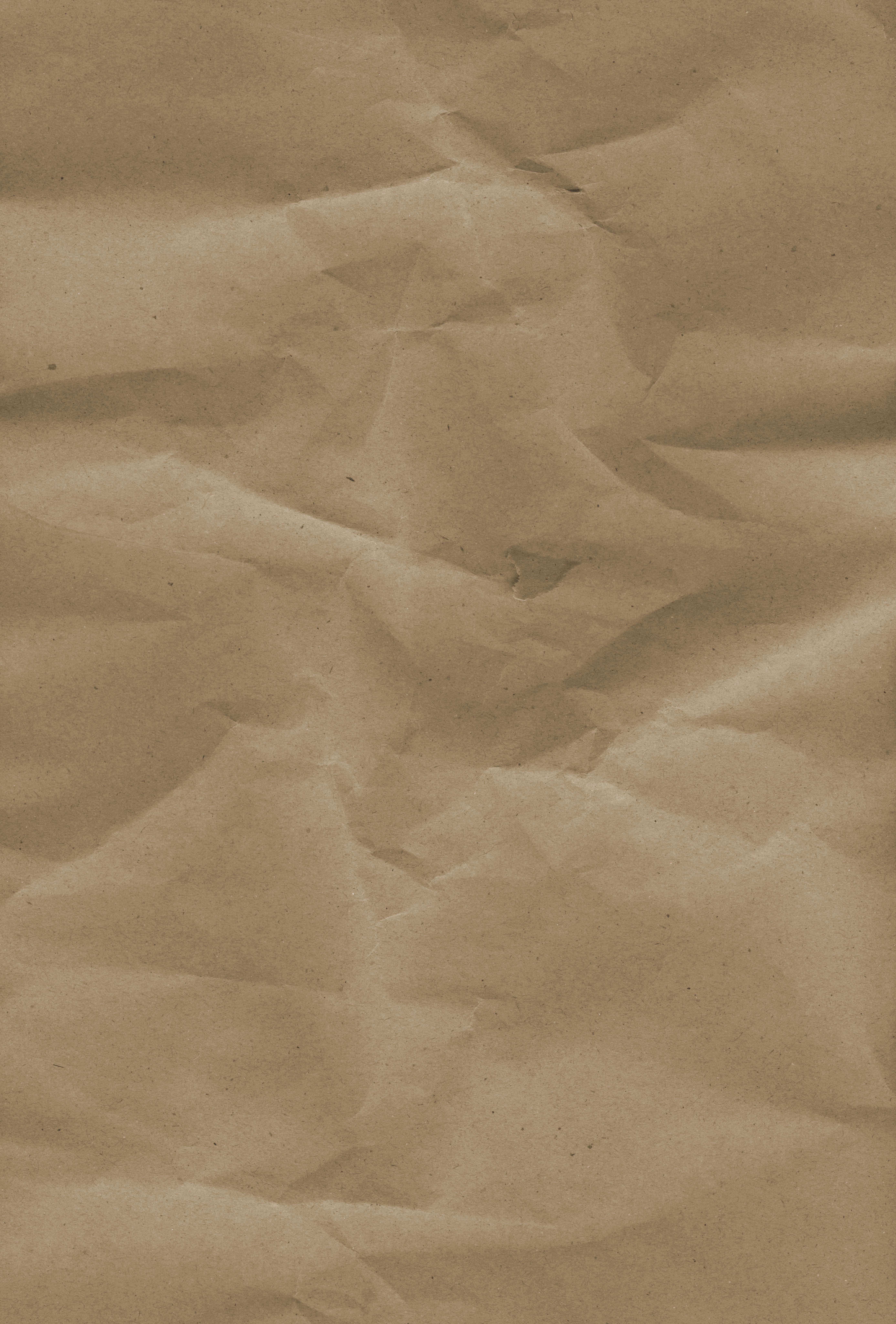 High-resolution image of brown craft paper with a wrinkled texture, suitable for backgrounds or design elements.