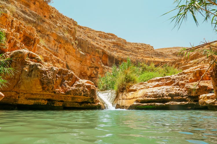 Water Flowing Into Lake In Oasis In Desert