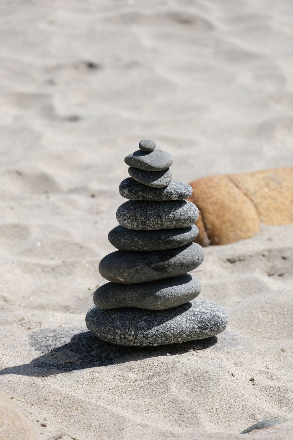 A Stack of Stones on Sand · Free Stock Photo