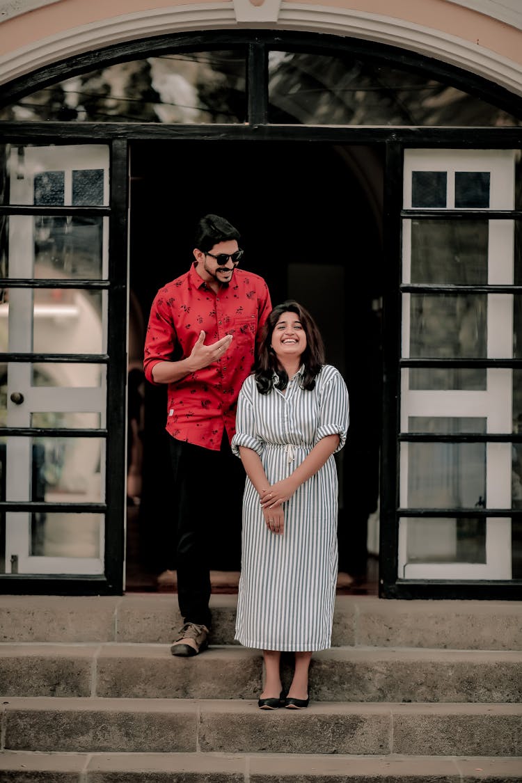 A Happy Couple Standing On A Concrete Stairs