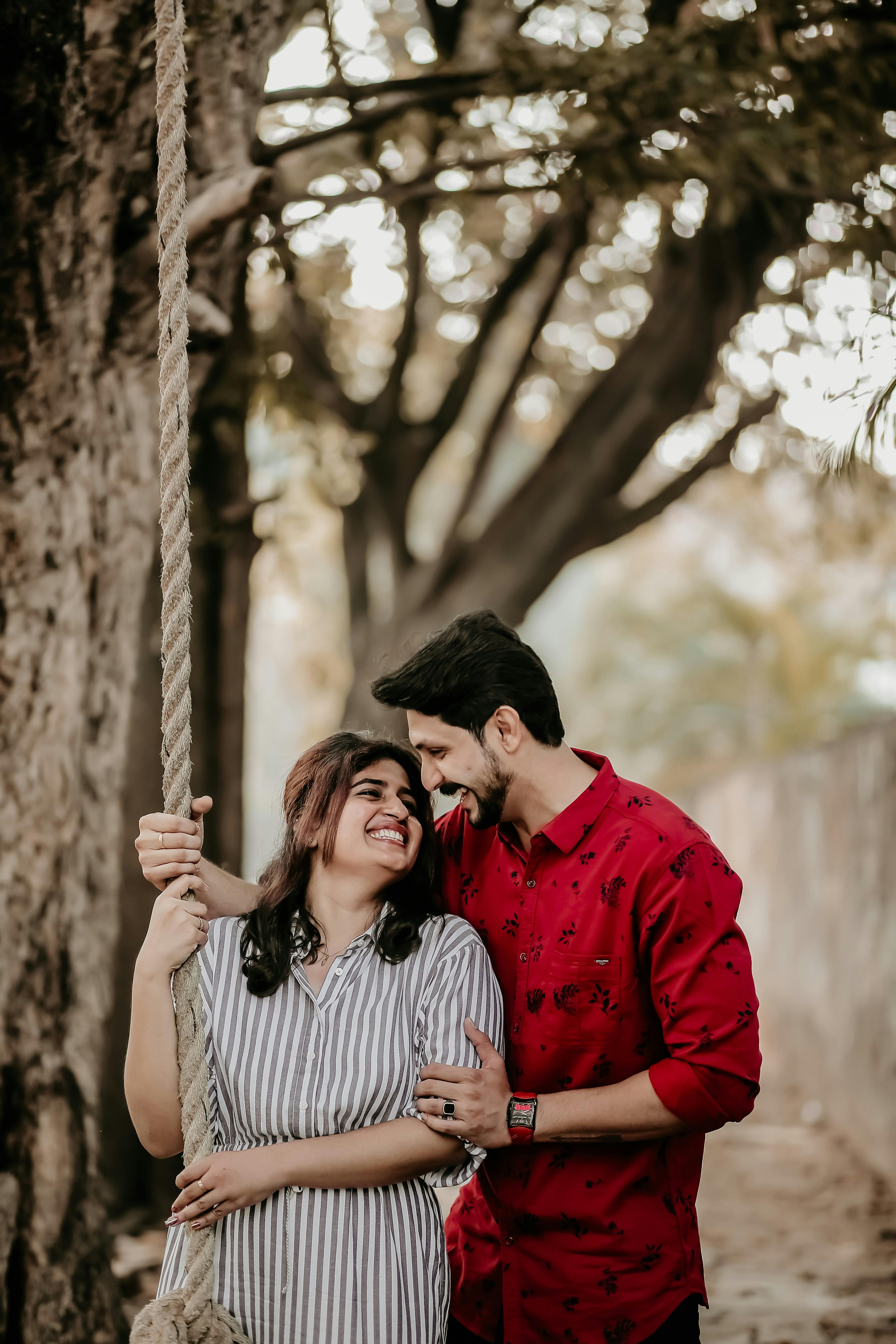 Happy Couple Looking at Each Other while Holding a Rope · Free Stock Photo