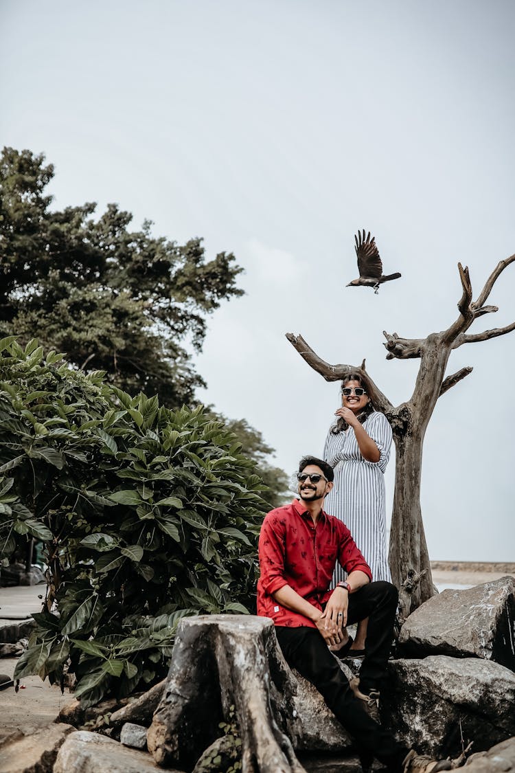 Bird Flying Above A Happy Couple