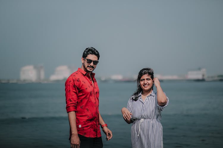 A Romantic Couple Standing Near The Sea