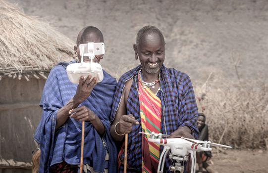 Maasai men wearing traditional clothing operate a drone in Arusha, Tanzania, blending tradition with technology.