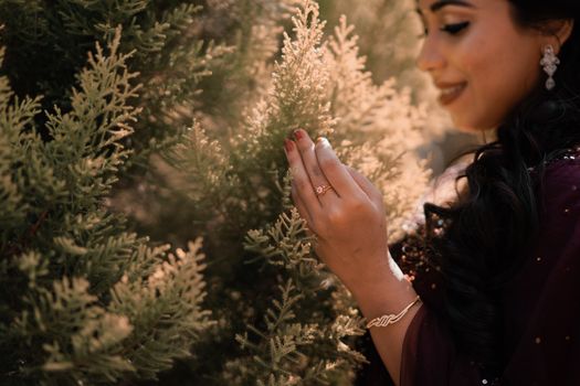 Woman Wearing a Gold Diamond Ring Holding Leaves