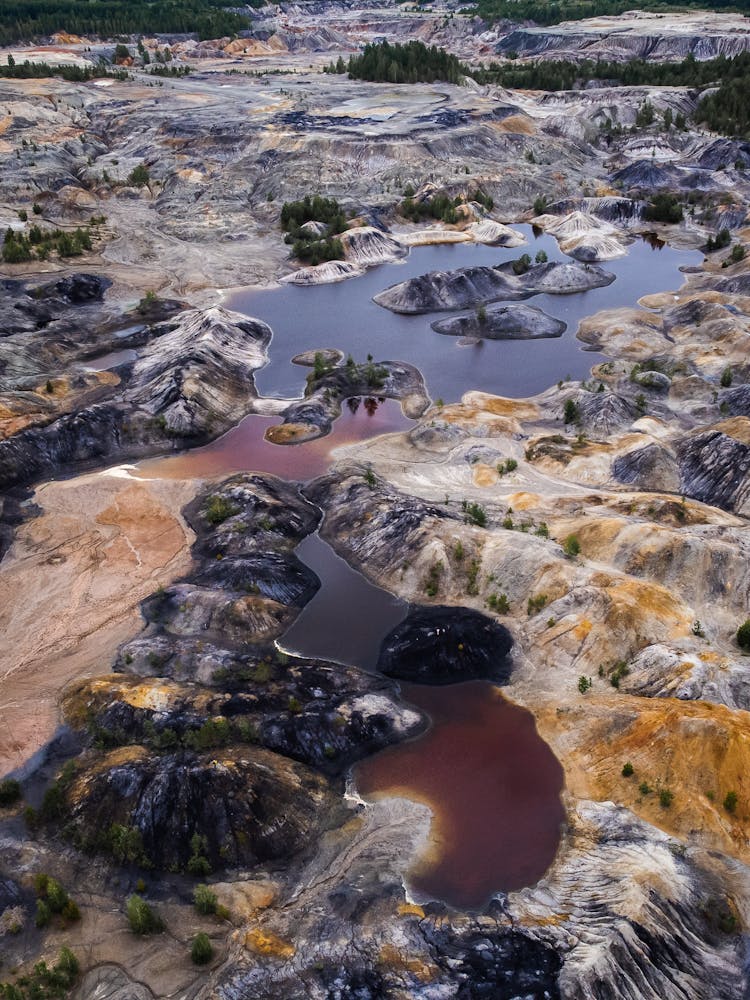 Aerial View Of Rocky Landscape With Brown Ponds