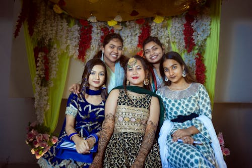 Group of Smiling Women Wearing Saris