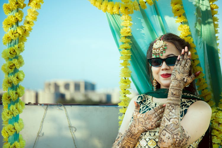 Woman Smiling And Posing In Traditional Dress With Mehndi Art Tattoos On Her Arms