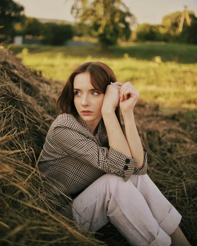 Woman Wearing Suit And Trousers Posing In Hay