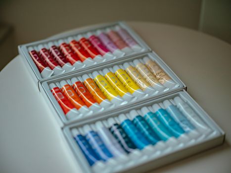A vibrant collection of acrylic paint tubes in various colors, perfect for artists.