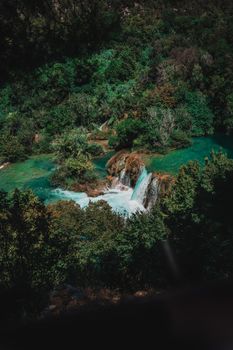 Beautiful cascading waterfalls in Krka National Park, Croatia, surrounded by lush greenery.