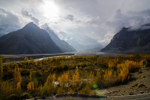 Free Stunning autumn view of mountain valley in Pakistan with vibrant colors and dramatic clouds. Stock Photo