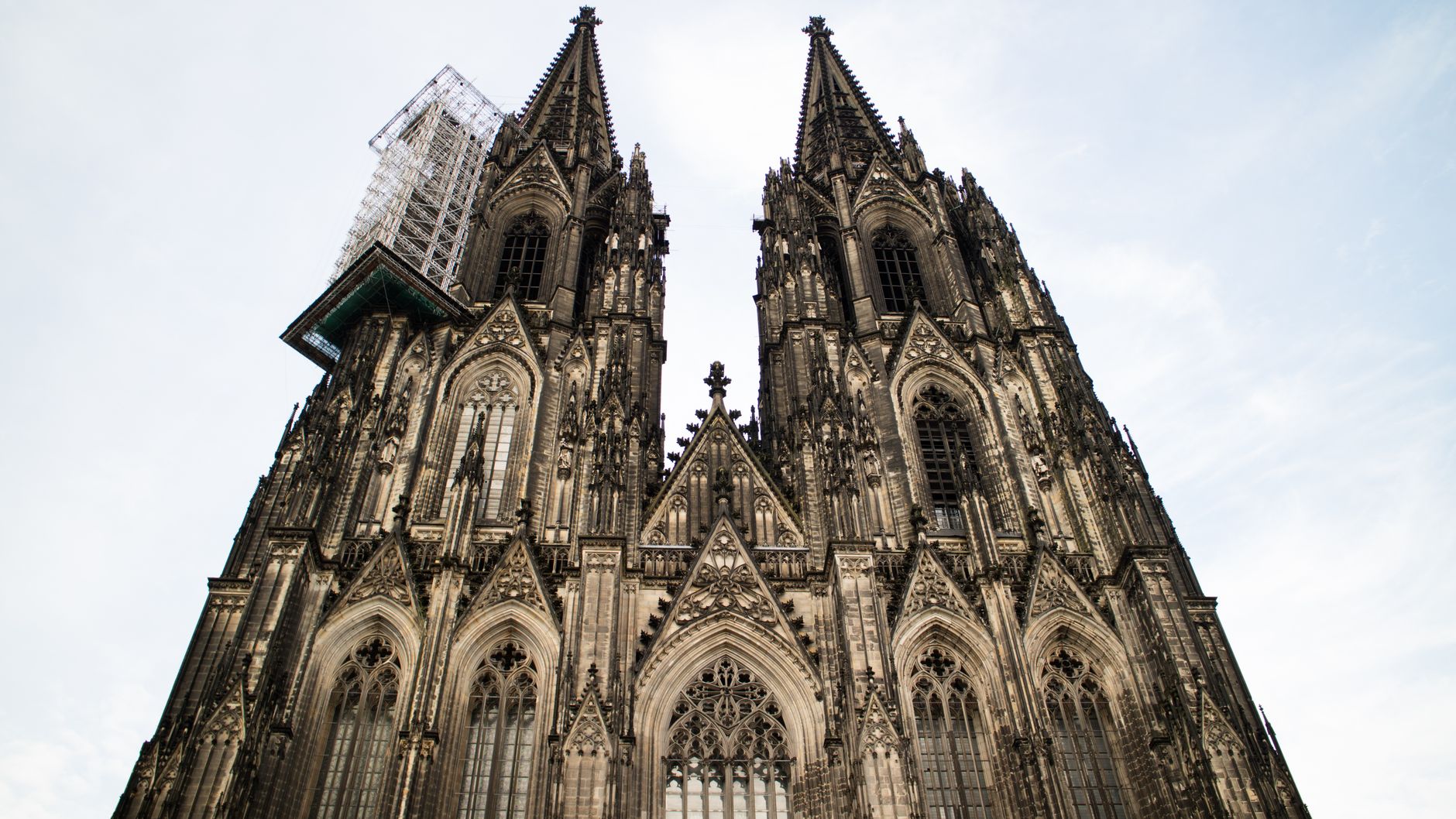 Stunning Gothic architecture of Cologne Cathedral in Germany against a clear sky.