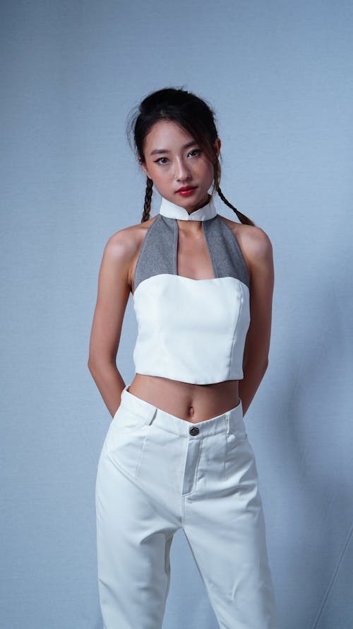 A Woman in White and Gray Top and White Pants