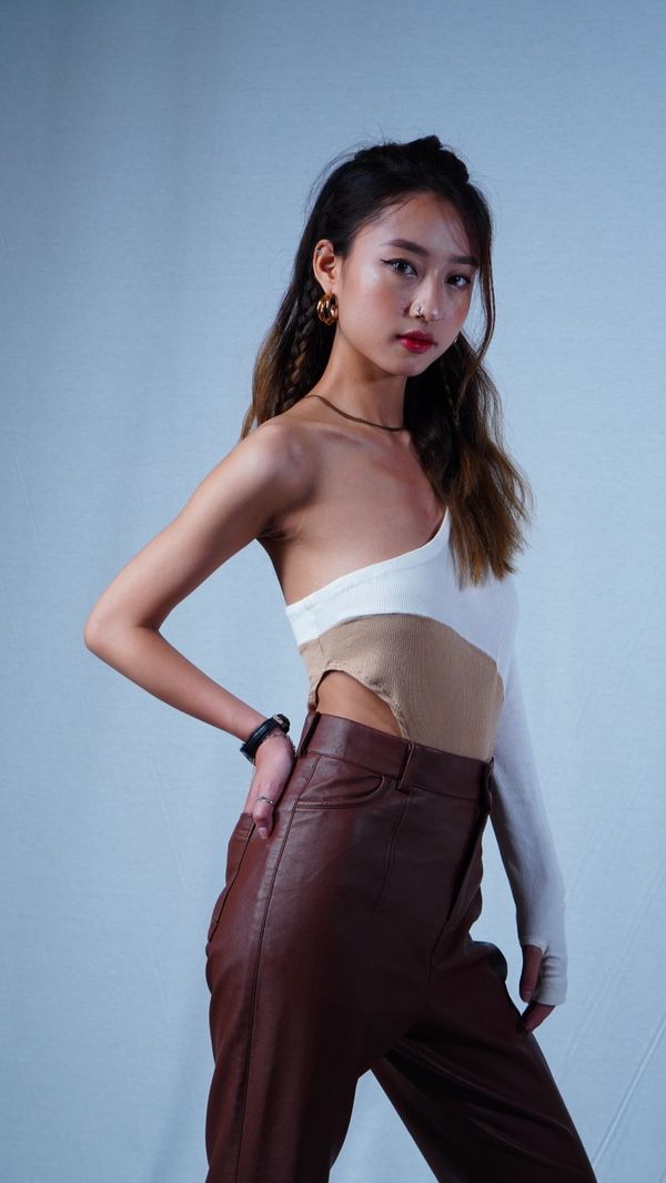 Woman in one shoulder top with trousers