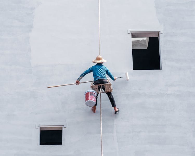 Person On Line Painting Wall Of Building