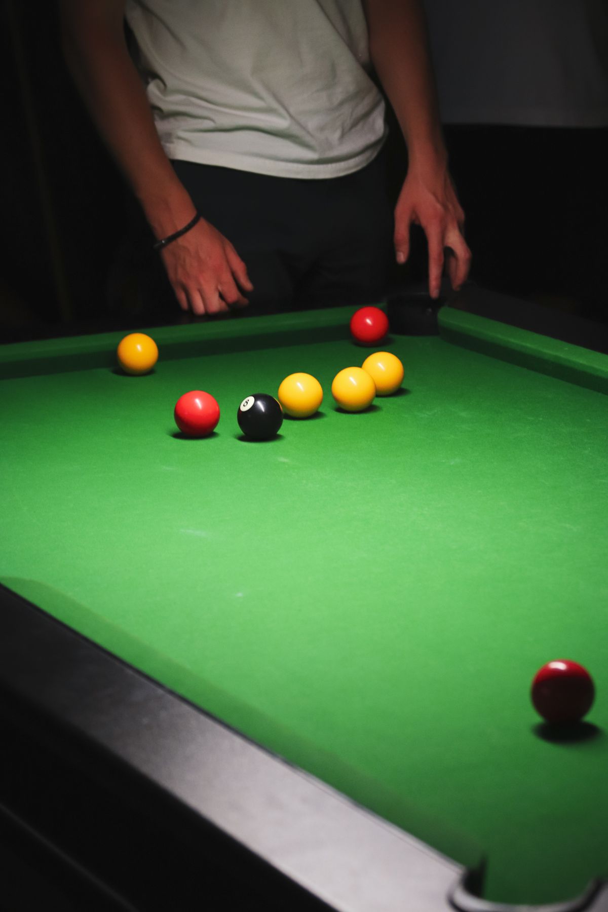 A snooker table under low warm light