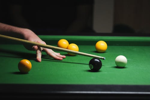 Close-Up Shot of a Person Playing Billiards