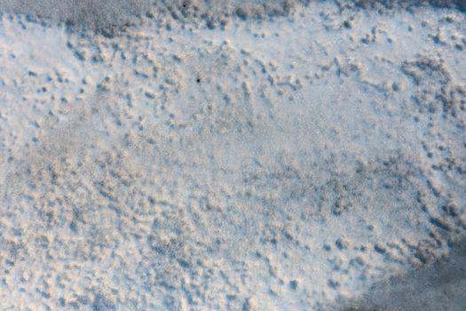 Close-up of detailed snow texture, capturing natural patterns in a Norwegian winter landscape.