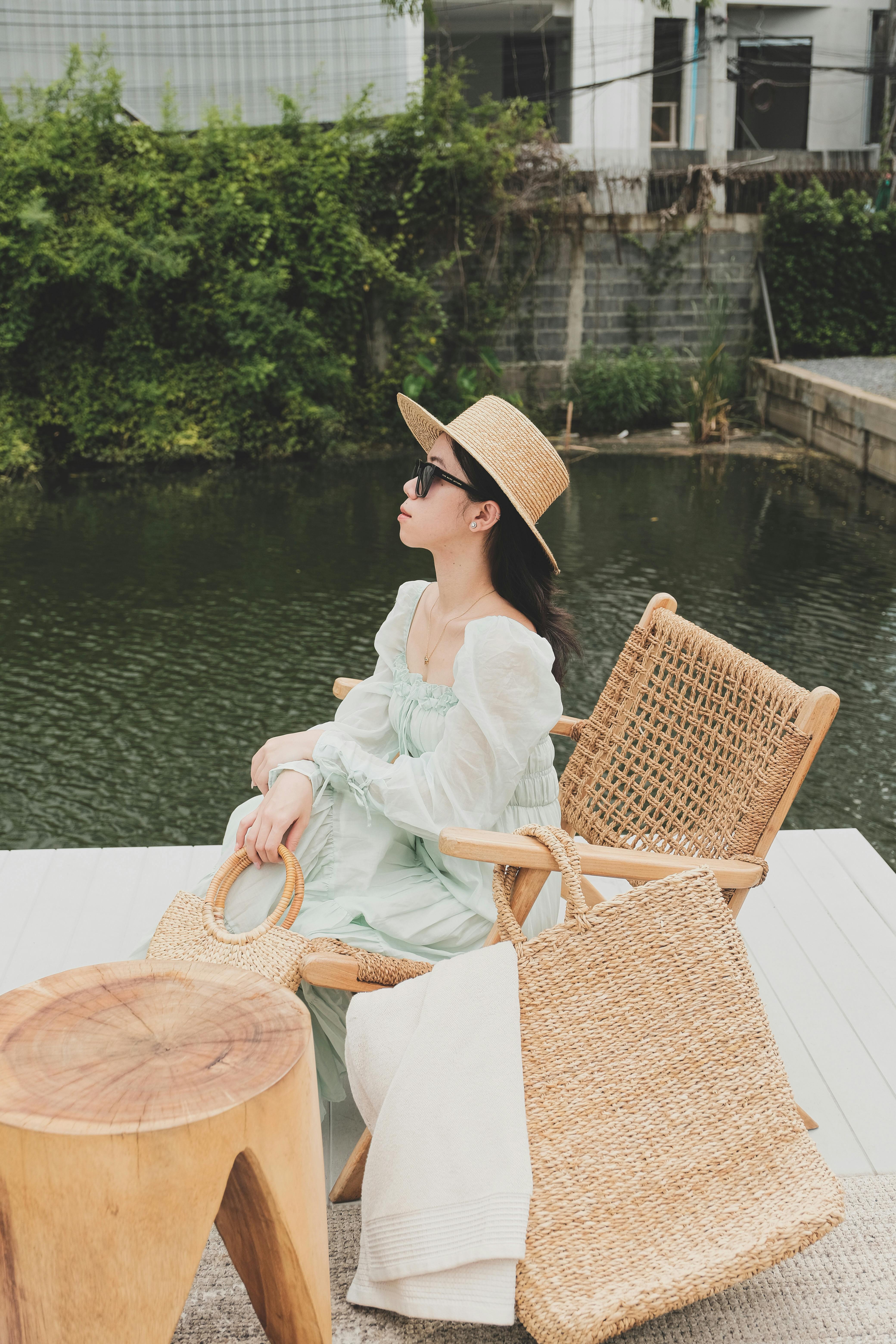 a woman wearing sunglasses and brown hat