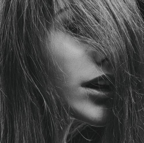 Grayscale Photography of Woman's Face Covered By Hair