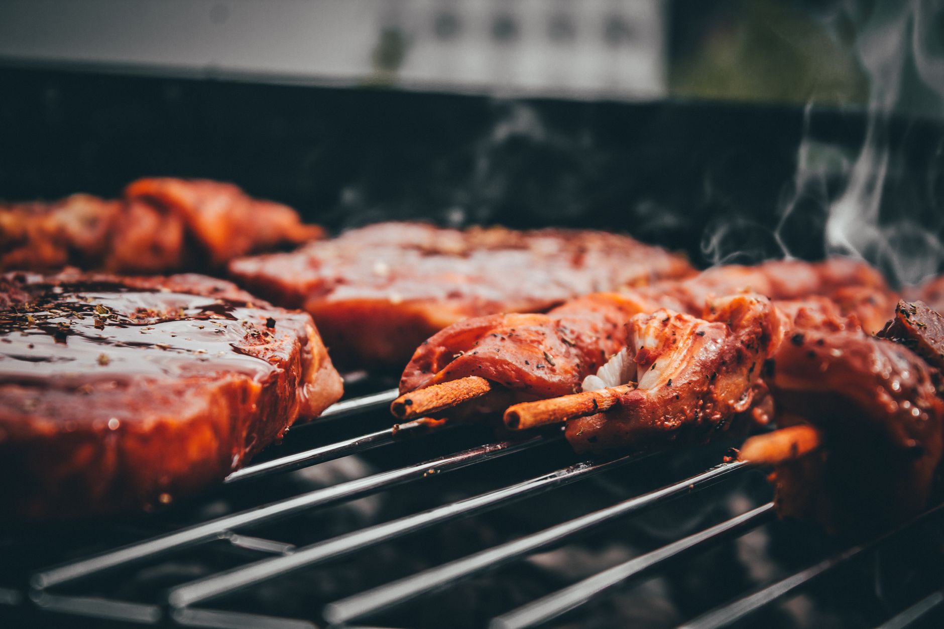 Close-up of tender grilled meat skewers with smoky flavor on a charcoal barbecue grill.