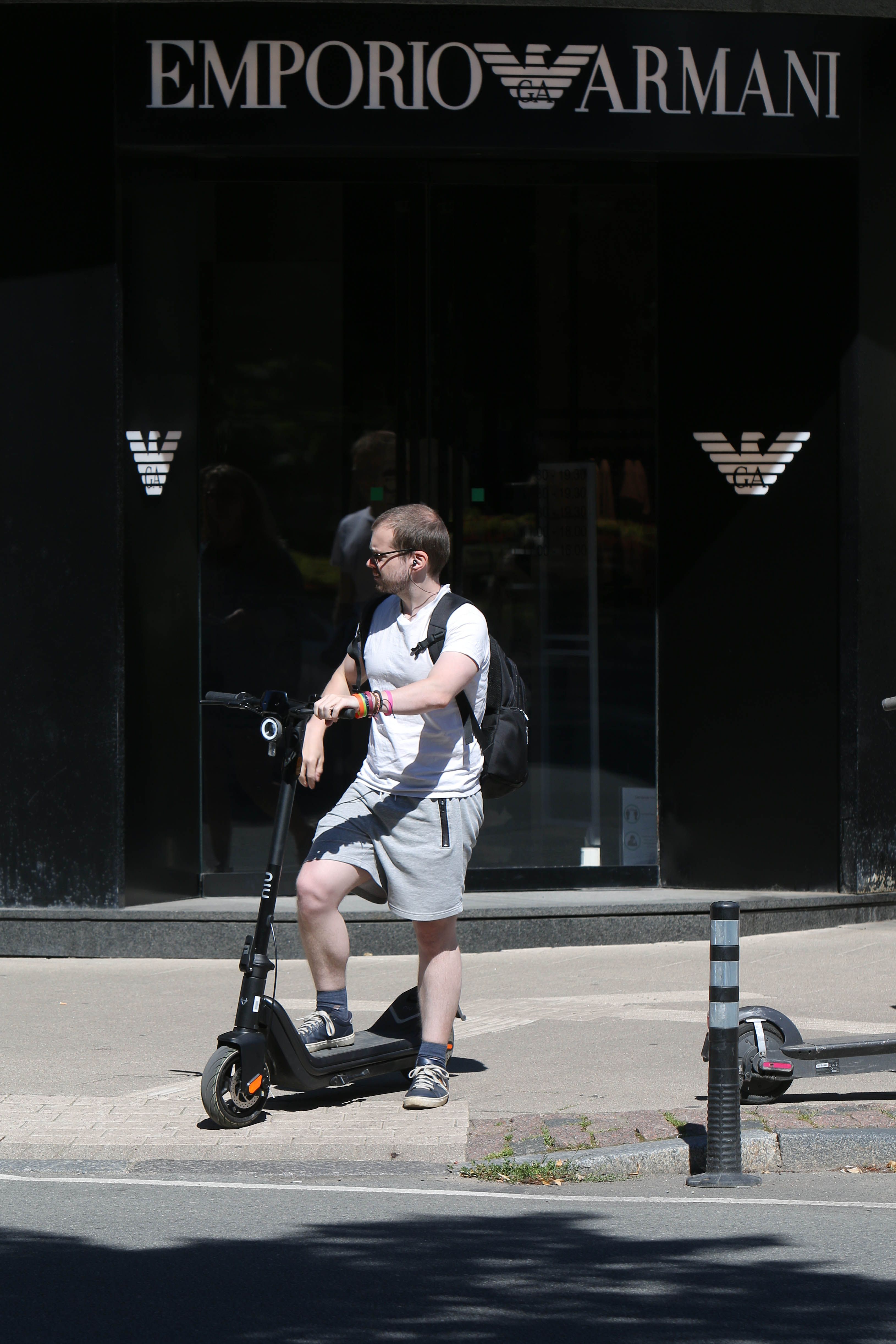 Photo of Person Riding a Scooted on Sidewalk · Free Stock Photo