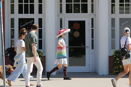 People Walking on Sidewalk near Door