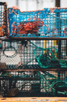 Vibrant stacked fishing cages with colorful ropes, perfect for nautical themes and coastal imagery.