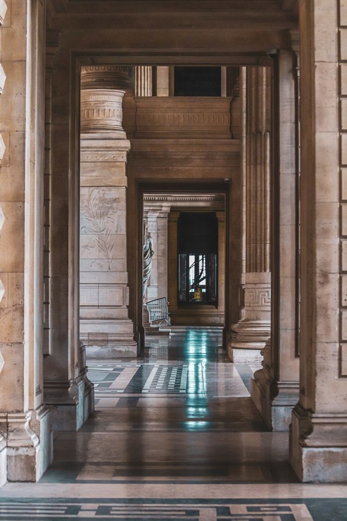 Stone colonnade receding down a classical hallway, by Boys in Bristol Photography on Pexels