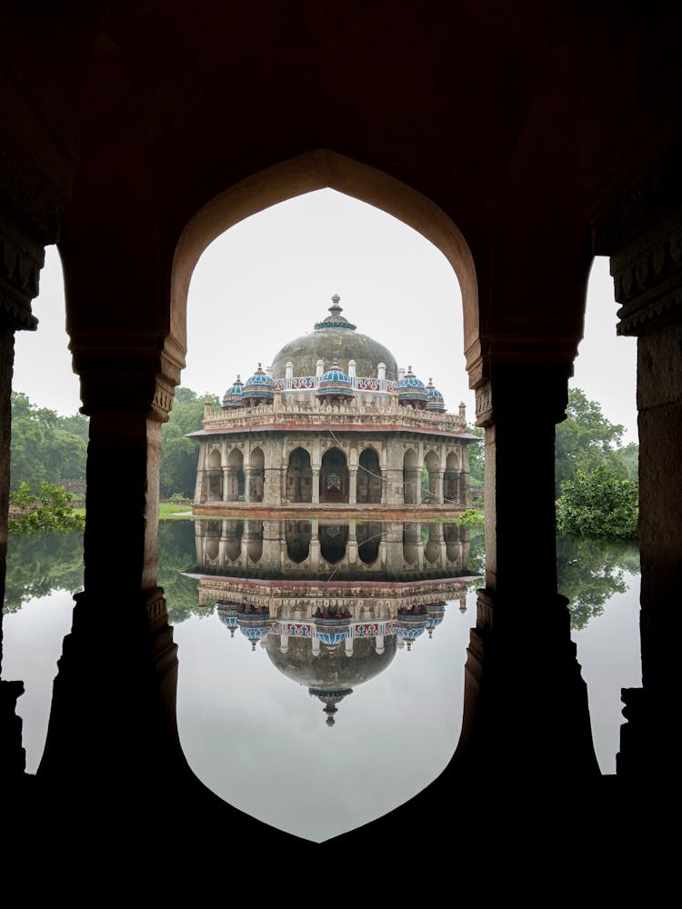 A Building With Reflection On Body Of Water