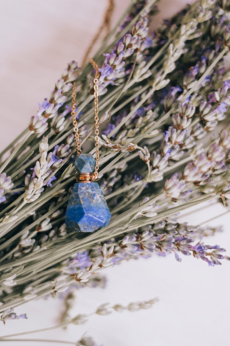 Crystal Bottle Jewelry On Wildflowers Background