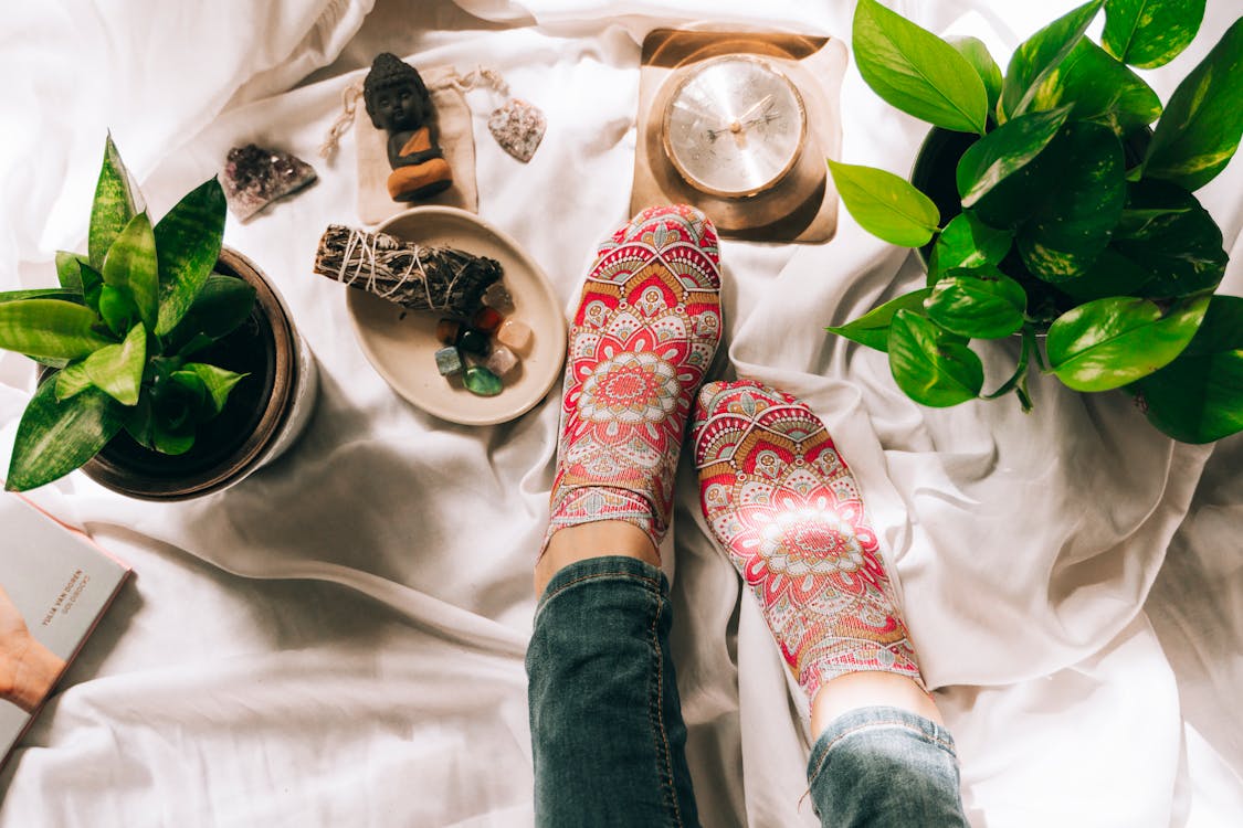 Woman Legs with Healing Crystals and Palo Santo Wood 